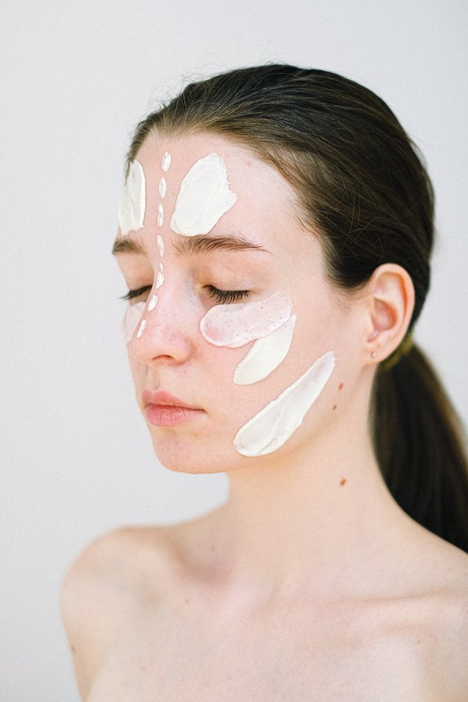 woman with skin cream on her face